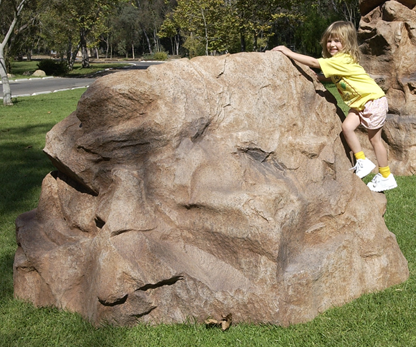 kid climbing landscape man made boulder backyard remodel